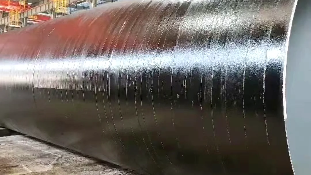 Reference application scene showing a black protective coating on a large steel pipe