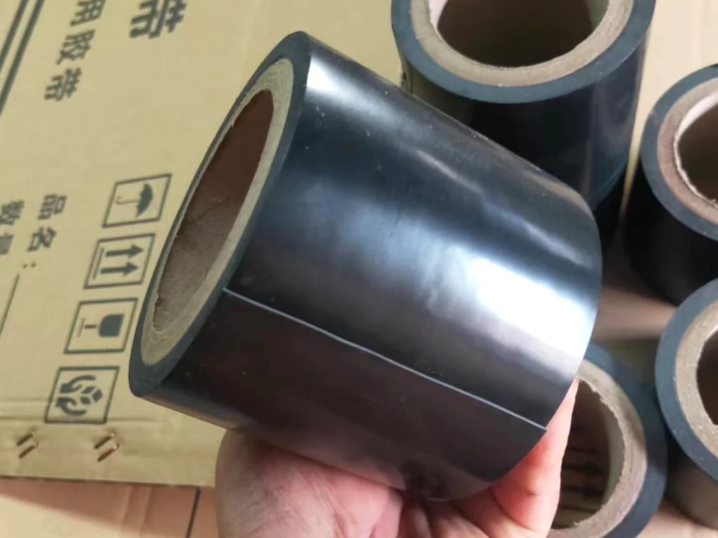 Real smooth black PVC tape rolls placed near carton packing
