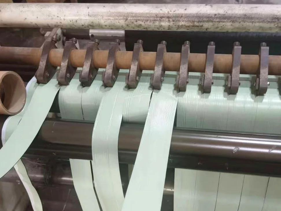 Real slitting machine cutting anti-corrosion tape into custom widths